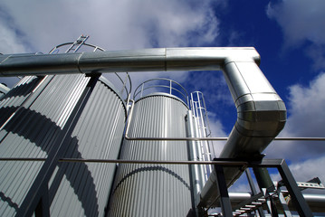Naklejka premium Industrial zone, Steel pipe-lines on blue sky