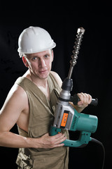 The builder  holds the professional puncher-hammer