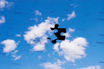 Blue sky with clouds (with a black hole as a puzzle piece)