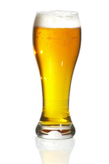 Glass of beer close-up with froth over white background
