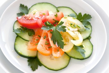 fresh salad with yellow, orange and red tomatoes