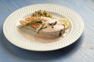 salmon with cream sauce on dish