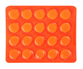 Close-up of pills in orange package isolated on white