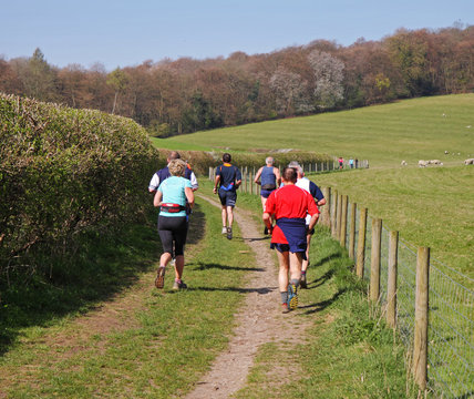A Group of Mature Joggers on a rural track