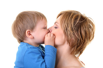 young little son embracing his pretty young mother