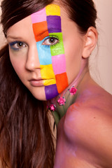 Obraz premium Young brunette woman with colorful makeup