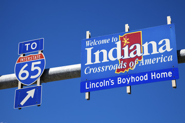 Welcome to Indiana road sign against blue sky. © Henryk Sadura