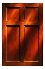 Rays of sunlight falling on antique panelled door