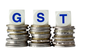Stacks of coins with the letters GST isolated on white