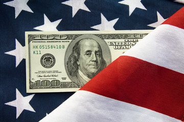 Hundred American dollars lying on a flag usa