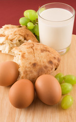 Fresh bread with eggs  and glass of milk