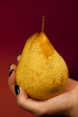 holding a pear