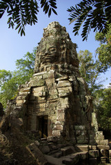 One tower in vegetation of the Bayon temple in Angkor