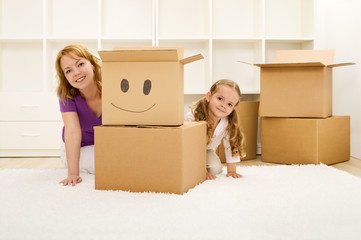 Happy woman and little girl unpacking