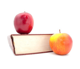The thick book and apples on a white background