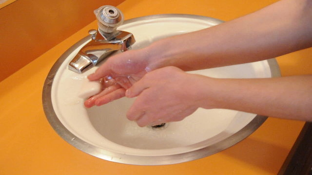Washing Hands in Bathroom Sink