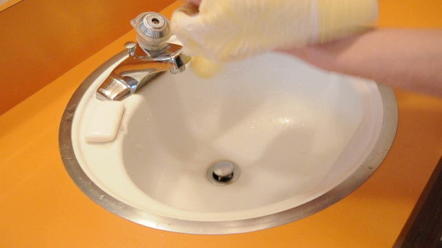 Drying hands above bathroom sink