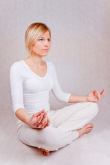 young woman practicing yoga - front-side view on white - obrazy, fototapety, plakaty