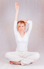 young woman stretching - on white background - obrazy, fototapety, plakaty