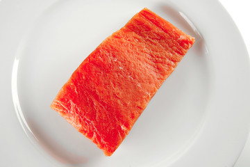 pink smoked salmon on white plate