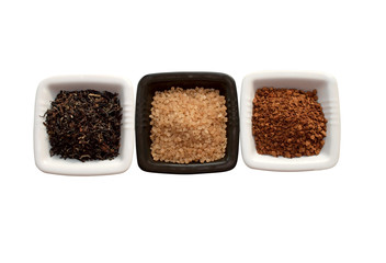 Isolated plates with tea, sugar and  granulated natural coffee