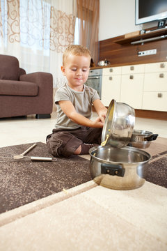 Little boy playing withcooking pots