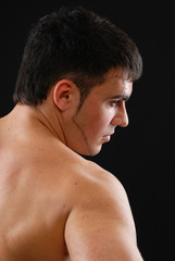 a handsome young man posing on a black background