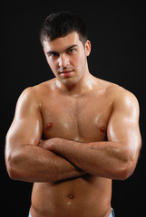 Fototapeta premium a handsome young man posing on a black background