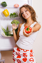 Cheerful young woman with fresh vegetables