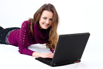 Fototapeta premium lying and smiling attractive woman with a laptop