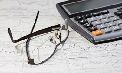 Balancing the Accounts. Calculator, glasses