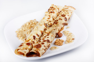 Pancake covered with honey and nuts