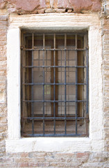 Fototapeta na wymiar Venice Window with metal bars