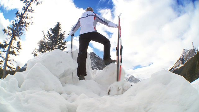 Young female with her skis & poles