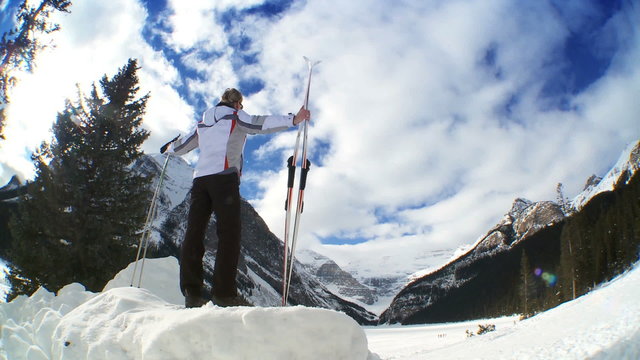 Young sporting female with her skis & poles