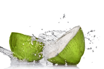 Green coconut with water splash isolated on white