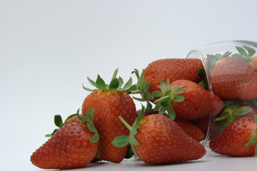 Strawberries spilling out of a glass