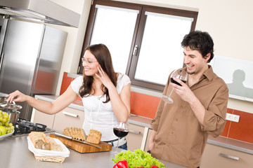 Happy couple cook together in modern kitchen