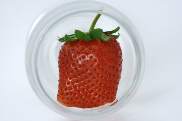 Oddly shaped strawberry inside a wine glass