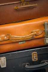 stack of old suitcases that have seen a lot of traveling