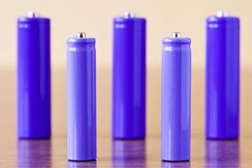 Foto op Aluminium group of a purple  alkaline batteries on the table © graja