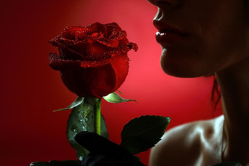 Woman with red rose, macro, on red background