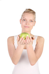 charming blonde with green apple in hands