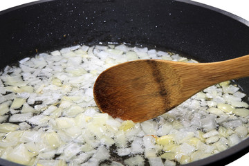 mixing fried onions wooden spoon