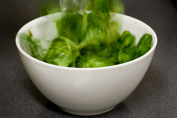 Organic salad being tossed