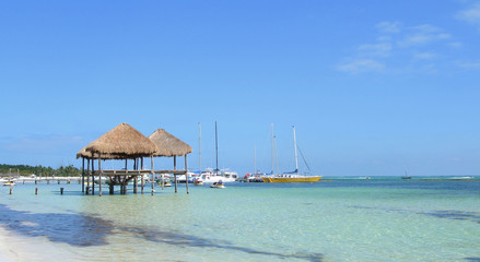 aribbean beach with huts at the Atlantic in Cancun, Mexico