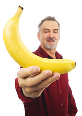 Man offers a yellow banana with outstretched arm