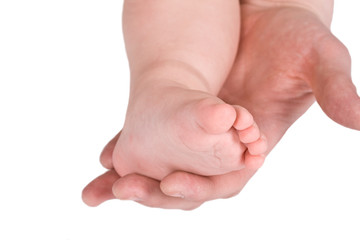 Children foot and adult hand