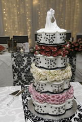 Multi layered wedding cake with bridal figurines