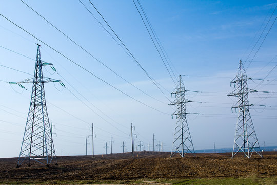 high-voltage lines going through a field